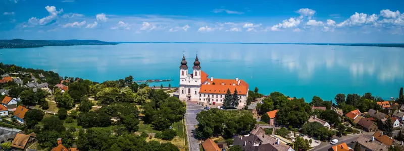 Tihany, Hungary - Aerial panoramic view of the famous Benedictine Monastery of Tihany (Tihany Abbey) with beautiful coloruful Lake Balaton at background